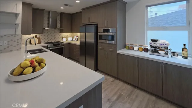 a kitchen with cabinets and steel stainless steel appliances