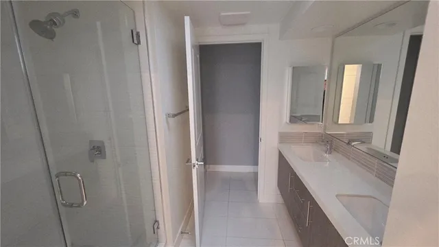 a bathroom with a granite countertop sink mirror and double