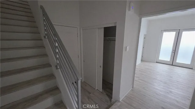 a view of entryway with wooden floor and stairs