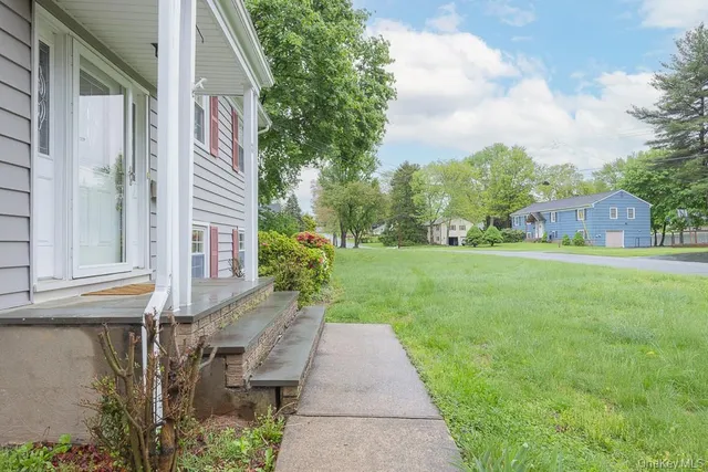 a backyard of a house with table and chairs