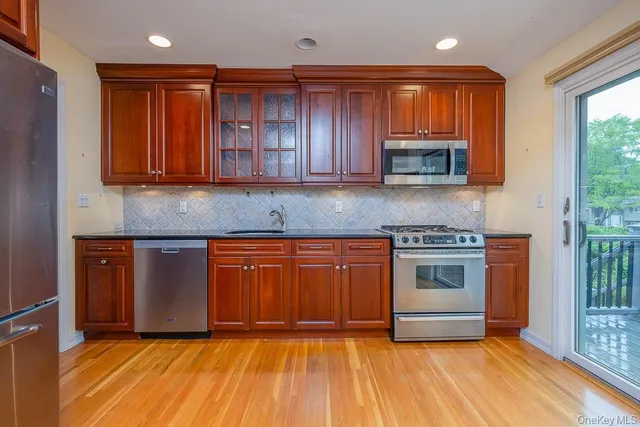 a kitchen with granite countertop a stove a sink and a microwave