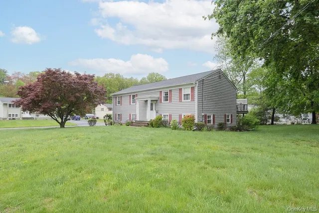 a view of a house with a backyard