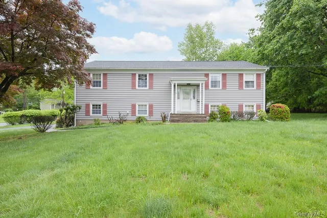 a front view of house with yard and green space