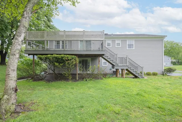 a view of a house with a yard and sitting area