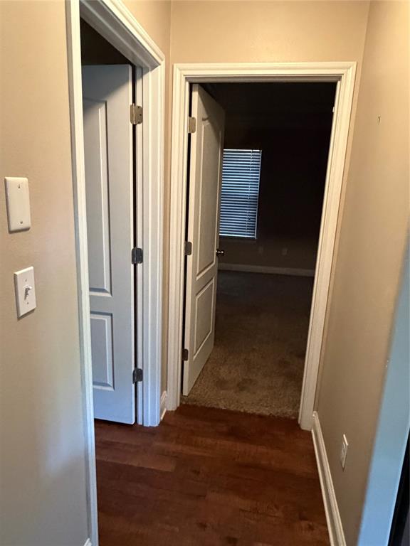 520 Big Red Circle Haughton, LA 71037 - Photo 19 of 25 Hallway with wood-finish flooring leading to rooms with carpeted floors