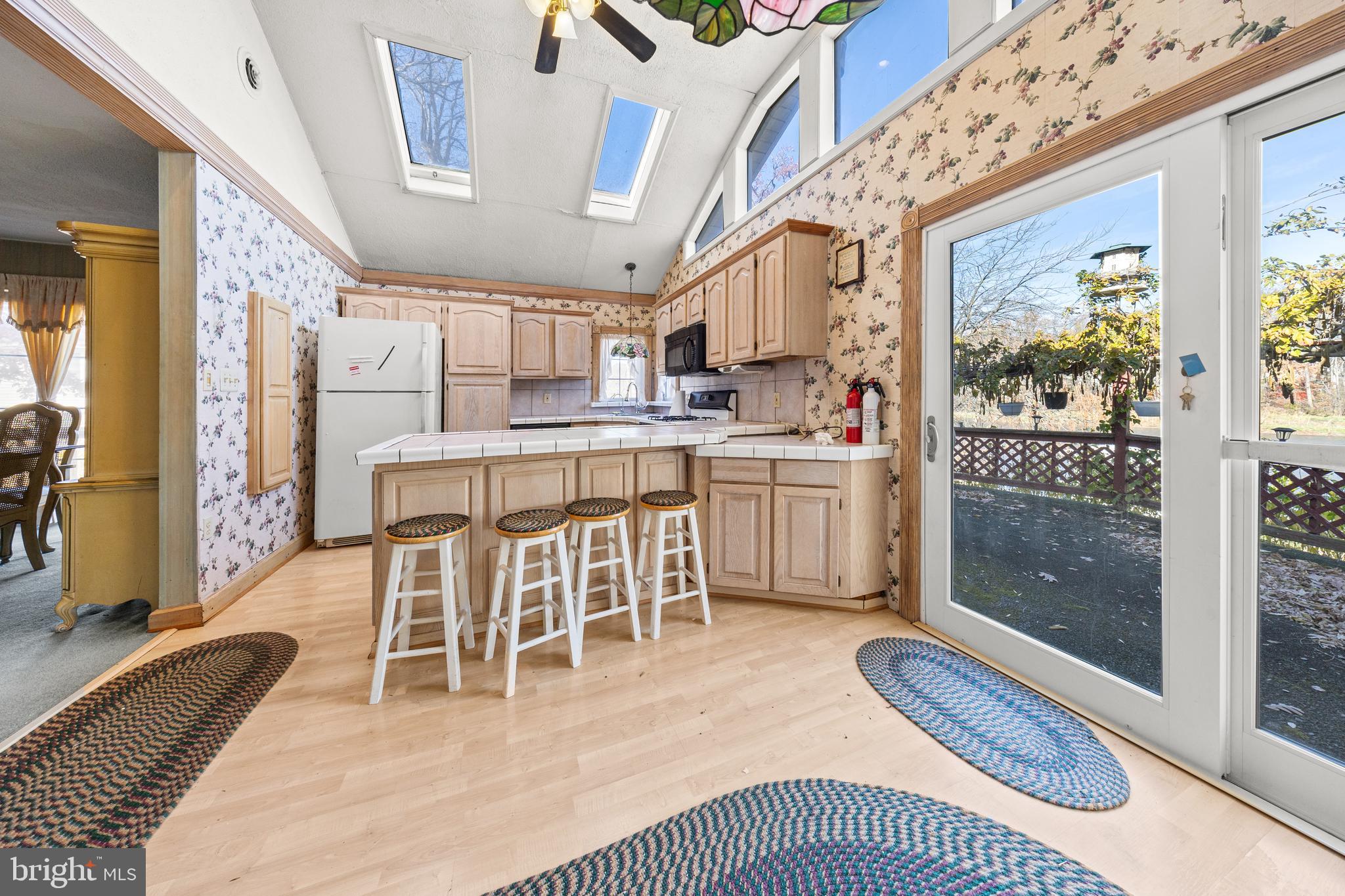 509 Neshaminy Road Croydon, PA 19021 - Photo 14 of 16 a dining room with stainless steel appliances kitchen island granite countertop furniture and a fireplace
