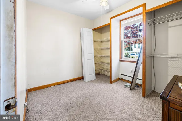 an empty room with windows and ceiling fan view