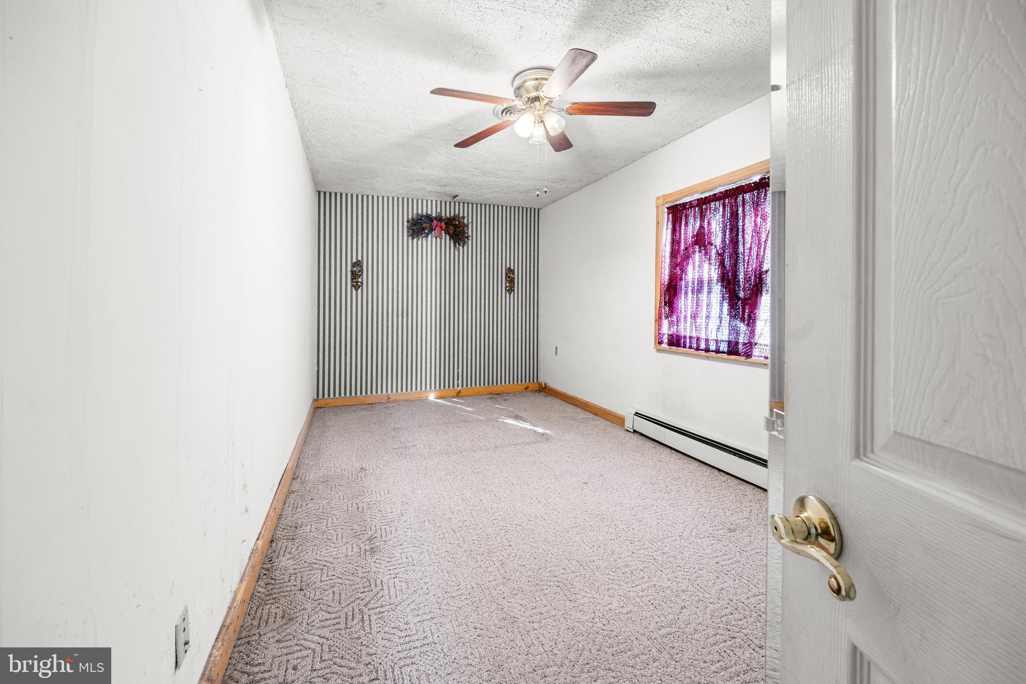 509 Neshaminy Road Croydon, PA 19021 - Photo 9 of 16 an empty room with windows and ceiling fan view