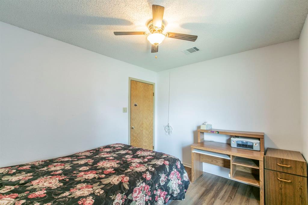 1936 Post Oak Drive Waco, TX 76705 - Photo 11 of 33 Bedroom featuring wood finished floors, a ceiling fan, and a textured ceiling