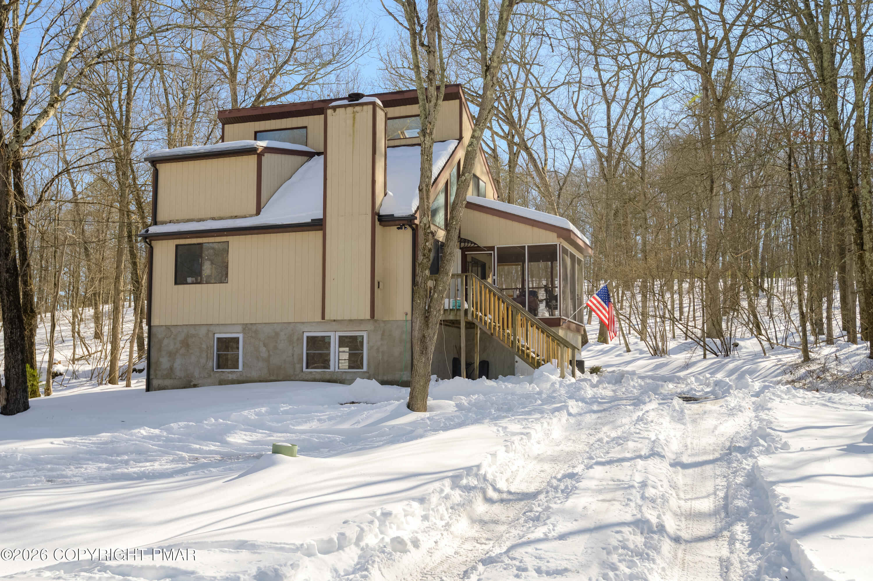 a view of a house with a snow on the road