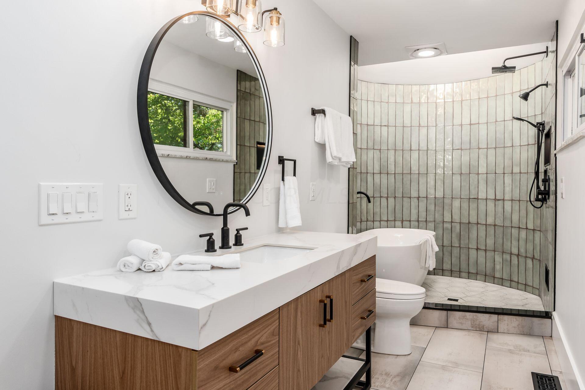 4610 Red Bank Road Galena, OH 43021 - Photo 39 of 88 Master bath features dual vanities each with storage and back-lit mirror, tile flooring, custom circular shower/bath combo.