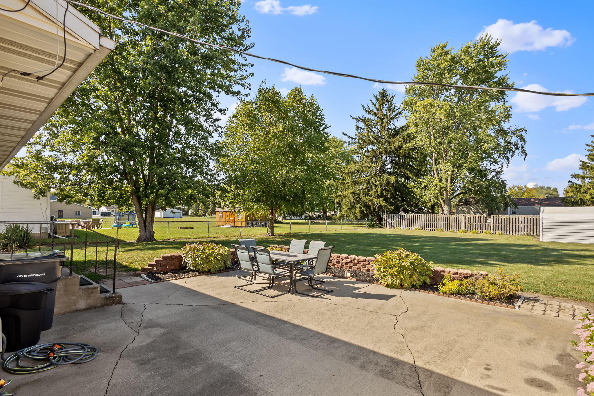 810 East Grace Street Rensselaer, IN 47978 - Photo 15 of 17 a view of a lake with a yard and large trees