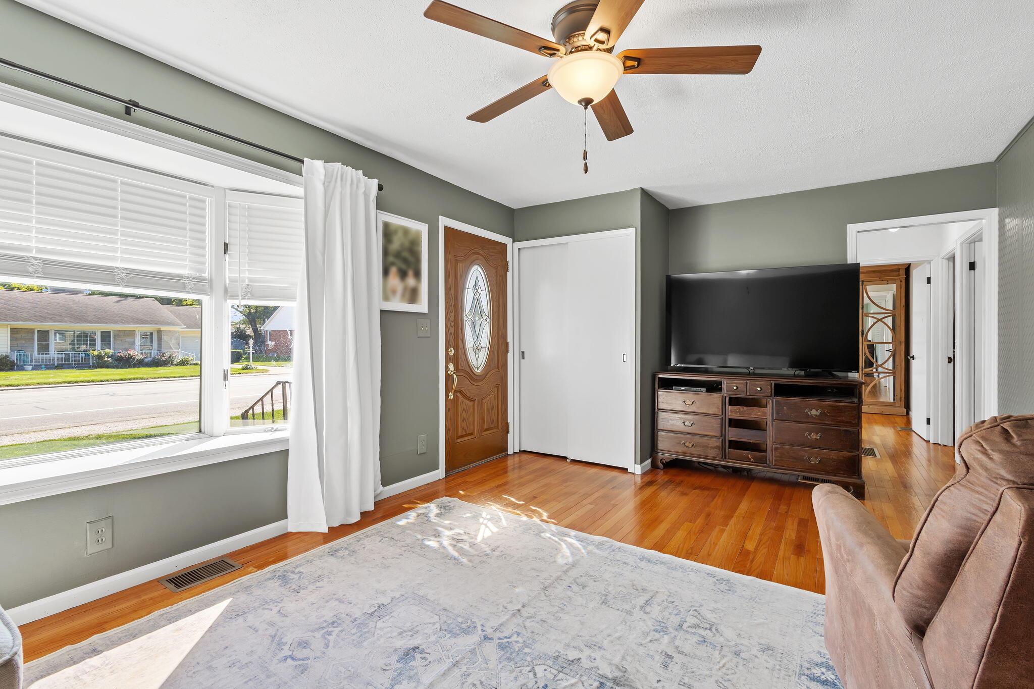 810 East Grace Street Rensselaer, IN 47978 - Photo 2 of 17 a bedroom with furniture and a flat screen tv