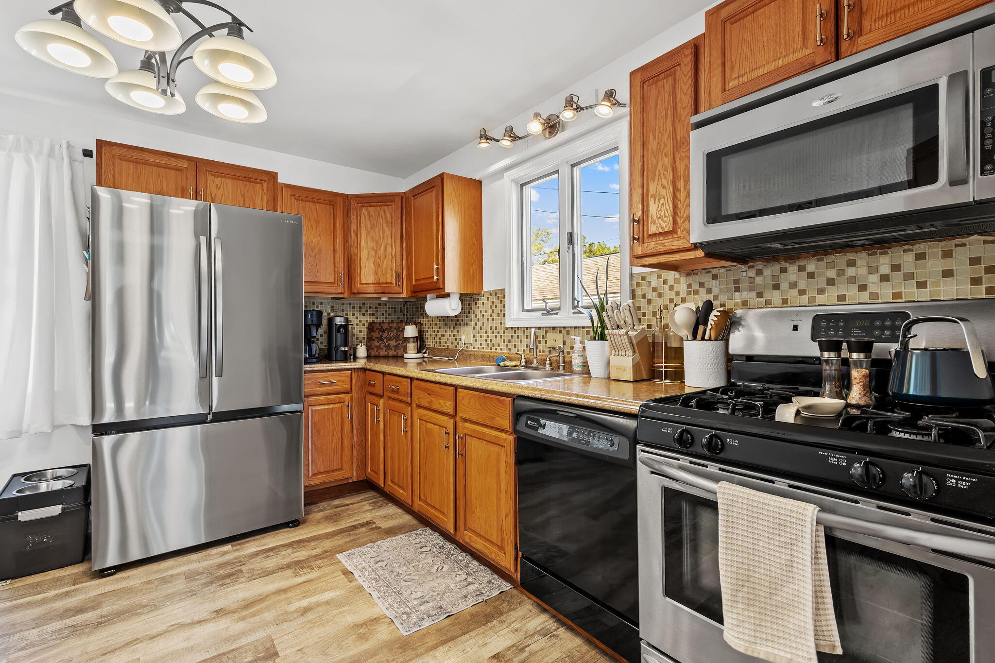 810 East Grace Street Rensselaer, IN 47978 - Photo 7 of 17 a kitchen with stainless steel appliances granite countertop a stove microwave refrigerator and cabinets