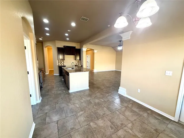 a kitchen with stainless steel appliances granite countertop wooden cabinets and a stove top oven