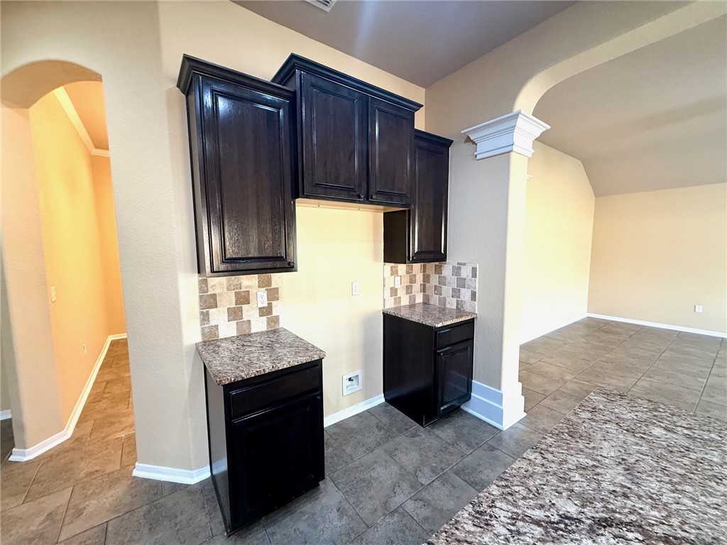 2205 Cardinales Lane Corpus Christi, TX 78414 - Photo 23 of 34 a kitchen with granite countertop a refrigerator and a stove top oven