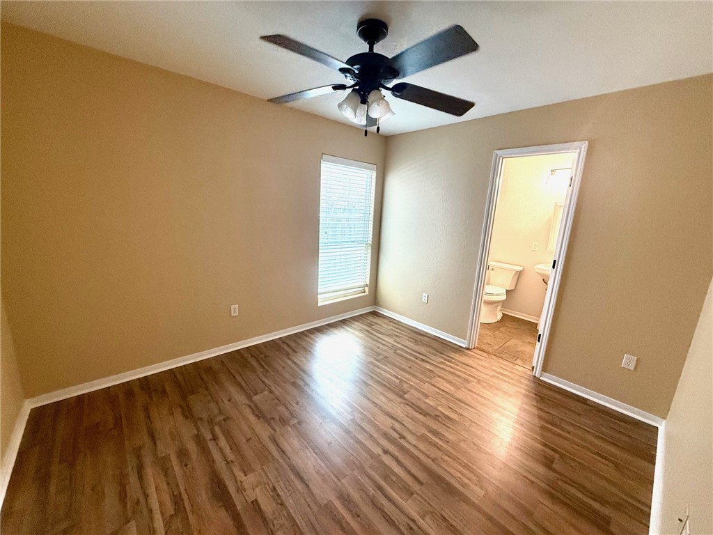 2205 Cardinales Lane Corpus Christi, TX 78414 - Photo 26 of 34 a view of an empty room with wooden floor and a ceiling fan