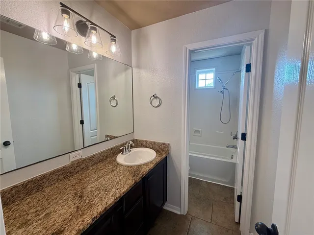 a white toilet sitting next to a bath tub