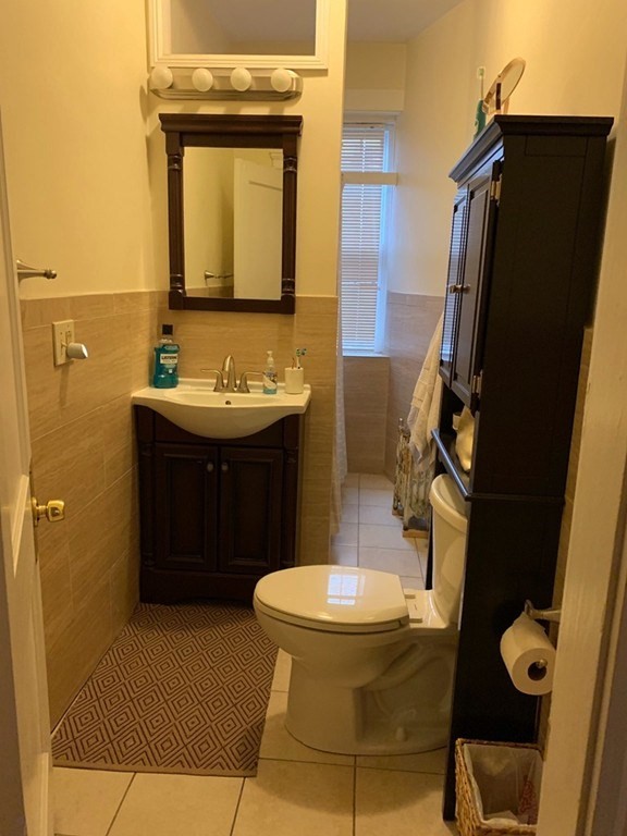16 Royce Road, Unit 5 Boston, MA 02134 - Photo 7 of 10 a bathroom with a sink and a mirror