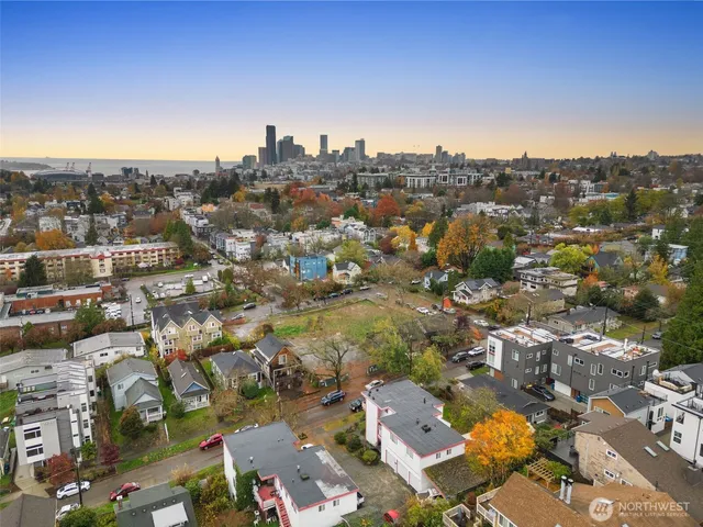 an aerial view of residential houses with city view