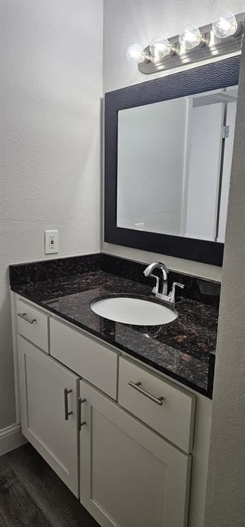 4845 Cedar Springs Road, Unit 167 Dallas, TX 75219 - Photo 4 of 10 a bathroom with a sink and a mirror