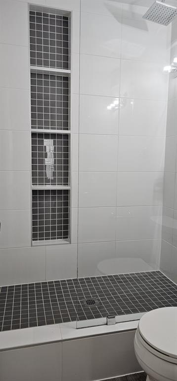4845 Cedar Springs Road, Unit 167 Dallas, TX 75219 - Photo 7 of 10 a bathroom with a toilet a sink and a shower