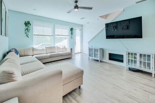a living room with fireplace furniture and a flat screen tv