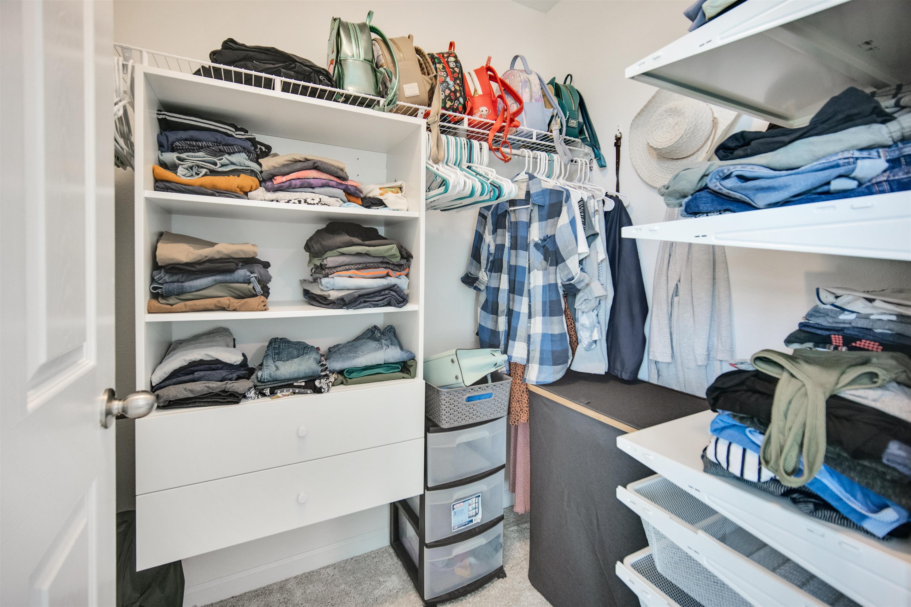 98 Ridge Lake Road St. Augustine, FL 32086 - Photo 15 of 31 a view of walk in closet with clothes and shoes