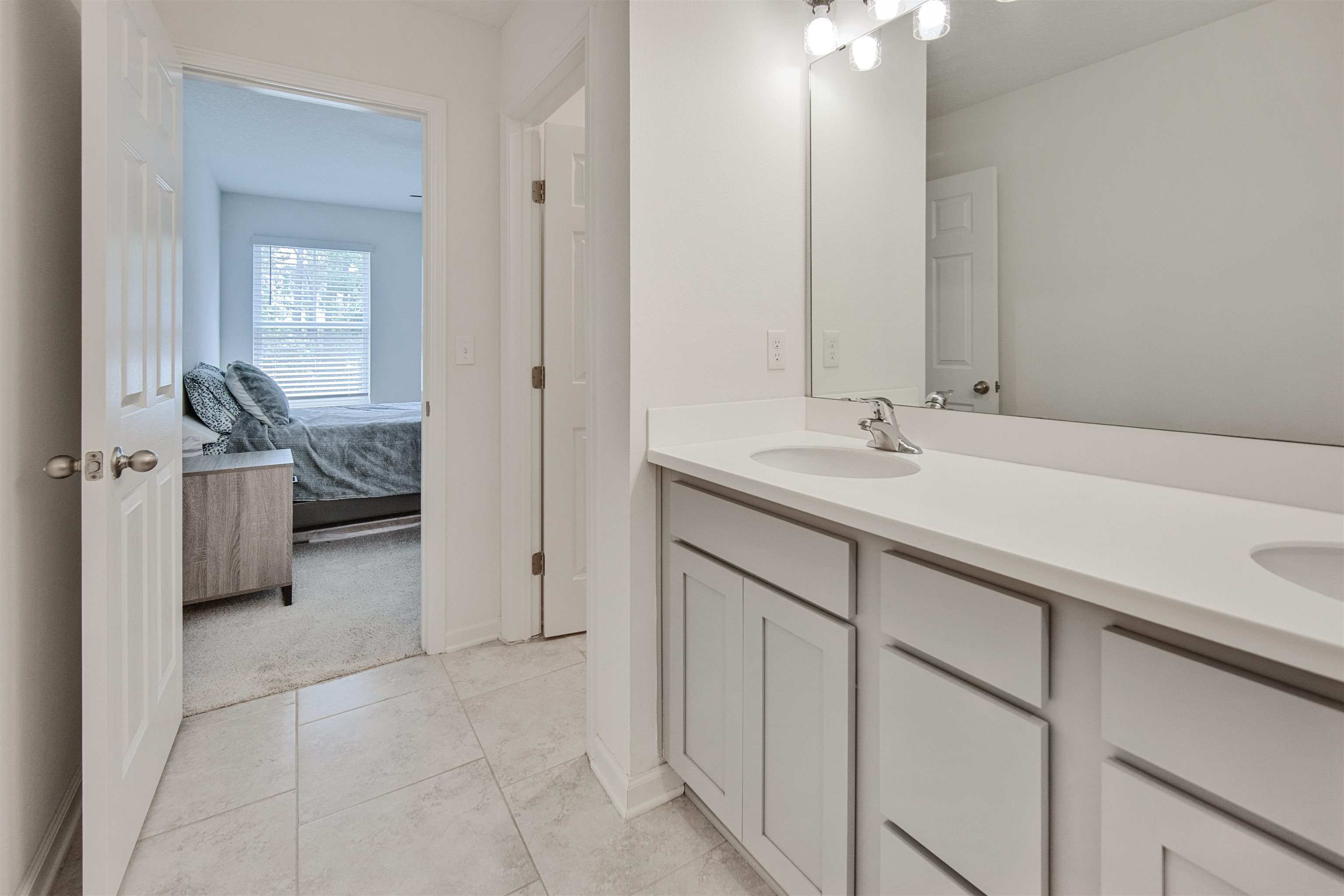 98 Ridge Lake Road St. Augustine, FL 32086 - Photo 16 of 31 a en suite bathroom with a sink and a mirror