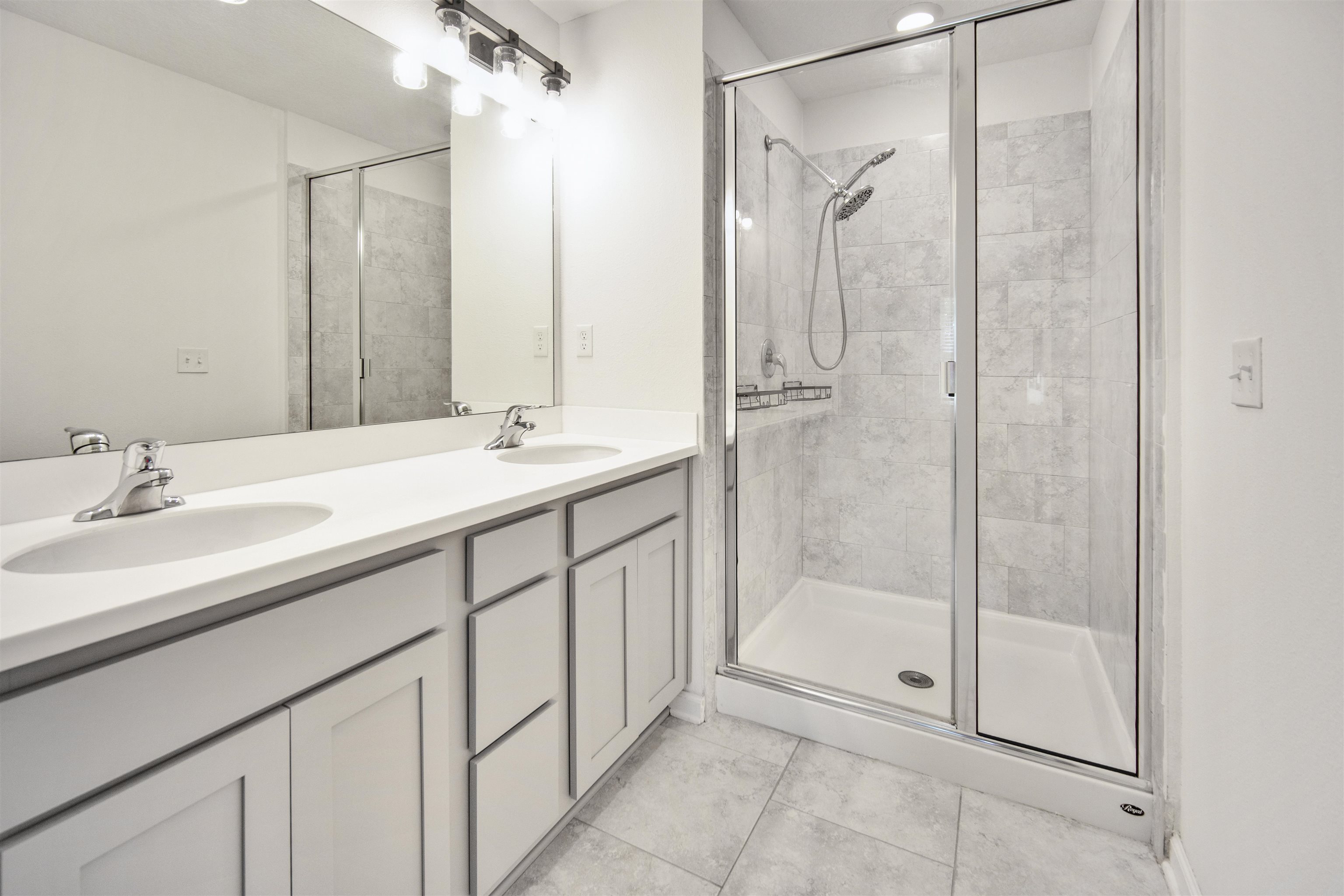 98 Ridge Lake Road St. Augustine, FL 32086 - Photo 17 of 31 a bathroom with a shower sink and mirror