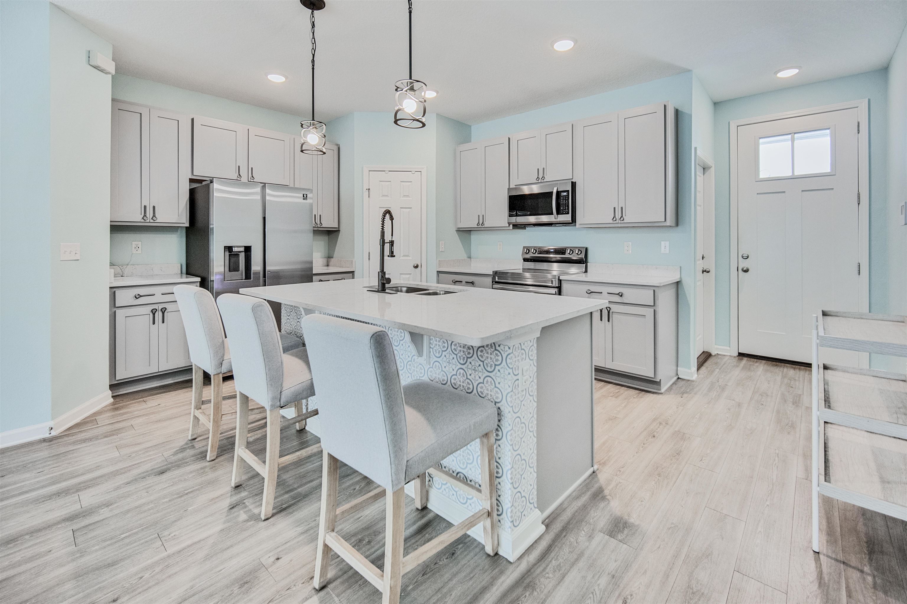 98 Ridge Lake Road St. Augustine, FL 32086 - Photo 2 of 31 a kitchen with stainless steel appliances a stove a sink refrigerator and a wooden cabinets