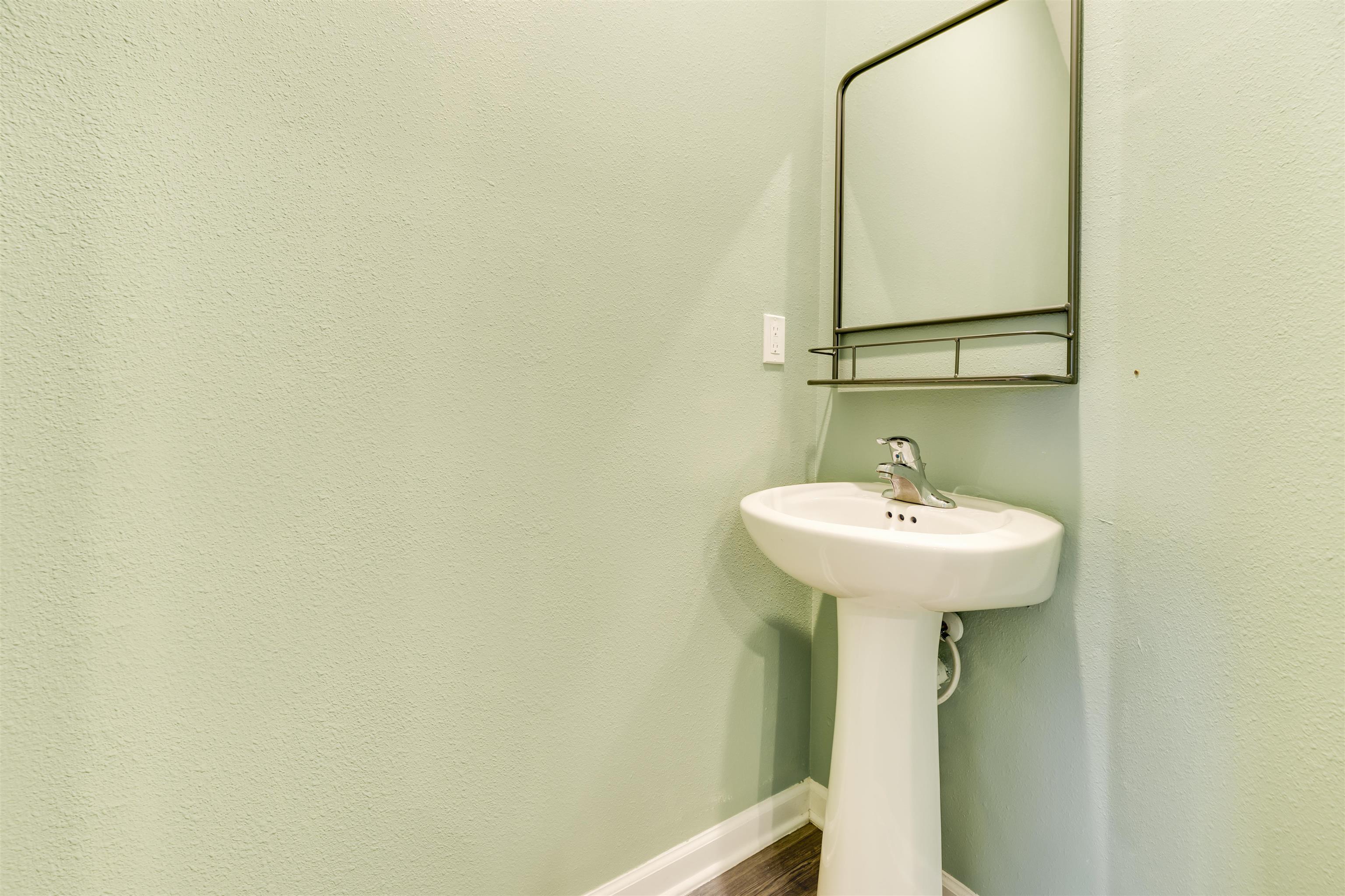 98 Ridge Lake Road St. Augustine, FL 32086 - Photo 24 of 31 a bathroom with a sink and mirror