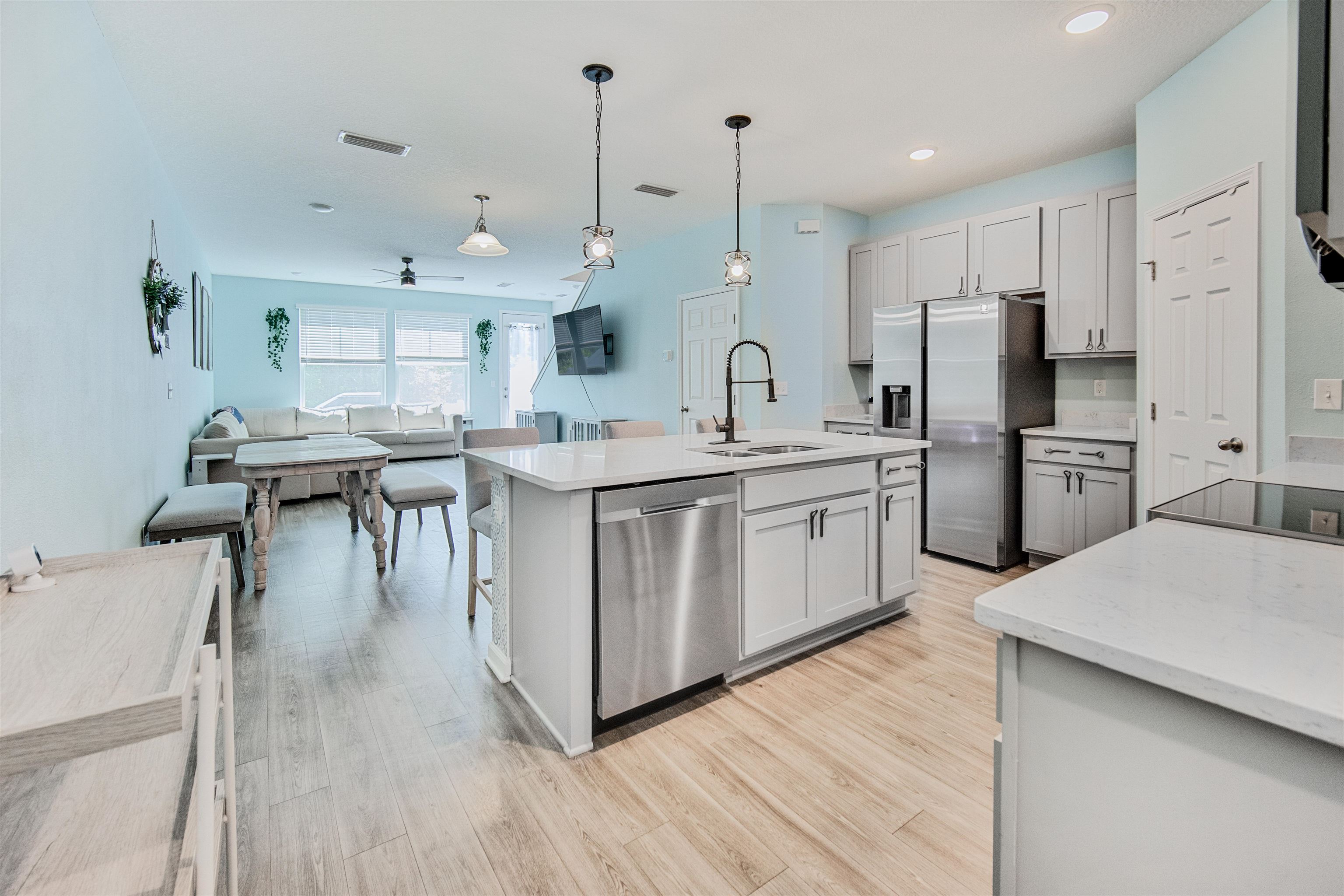 98 Ridge Lake Road St. Augustine, FL 32086 - Photo 6 of 31 a kitchen with stainless steel appliances kitchen island a hardwood floor and a view of living room