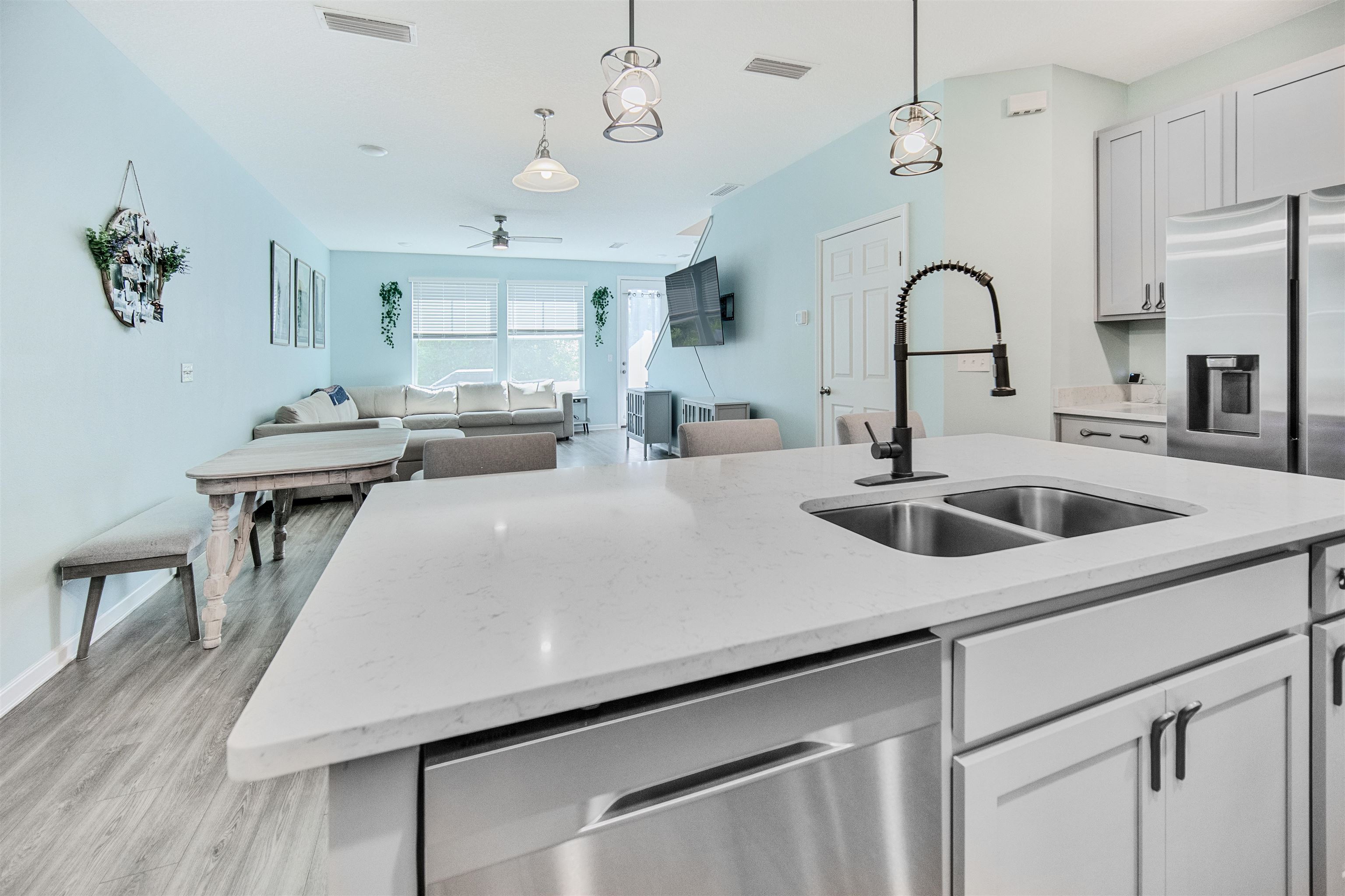 98 Ridge Lake Road St. Augustine, FL 32086 - Photo 7 of 31 a kitchen with a stove a chandelier and wooden floor