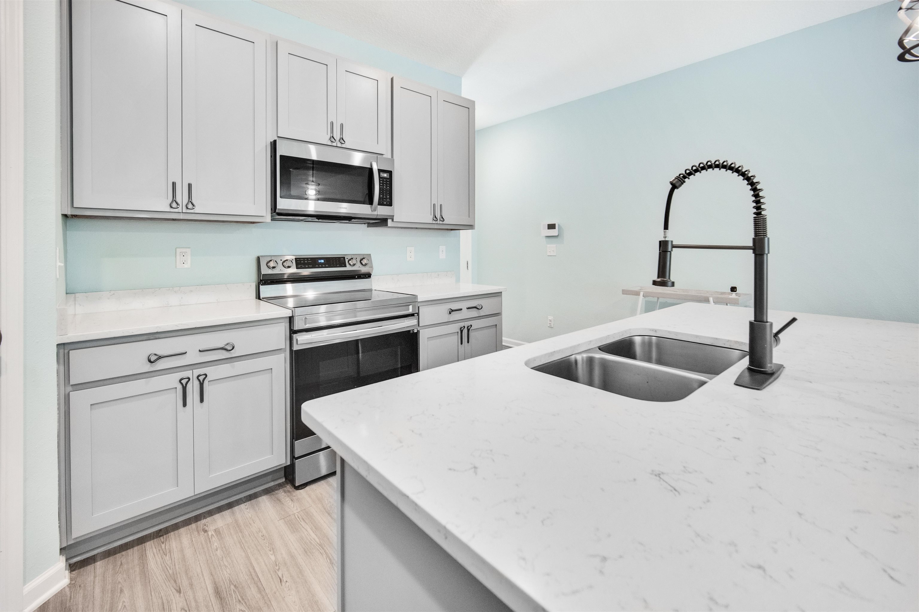 98 Ridge Lake Road St. Augustine, FL 32086 - Photo 8 of 31 a kitchen with a sink a stove and cabinets