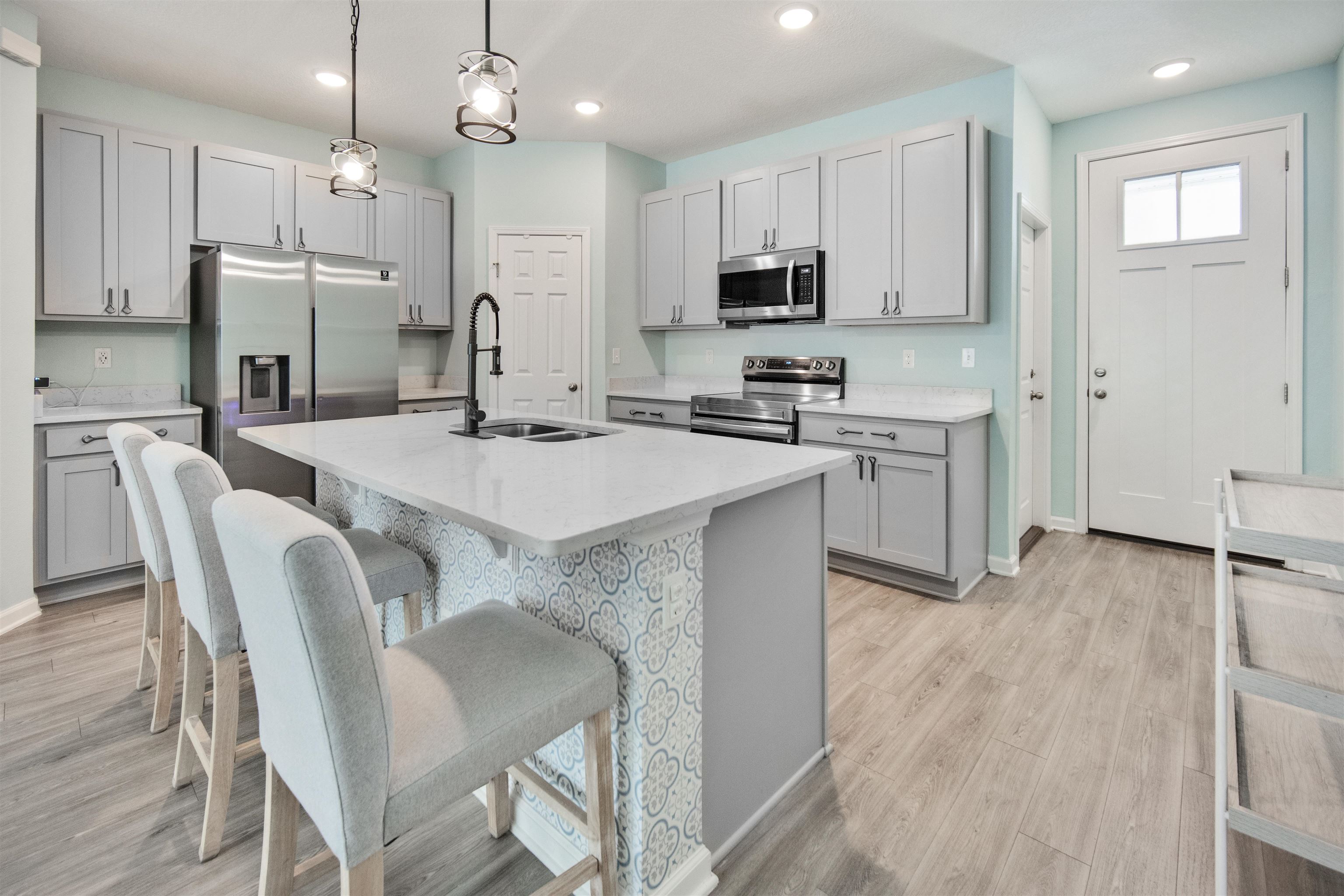 98 Ridge Lake Road St. Augustine, FL 32086 - Photo 9 of 31 a kitchen with refrigerator cabinets and wooden floor