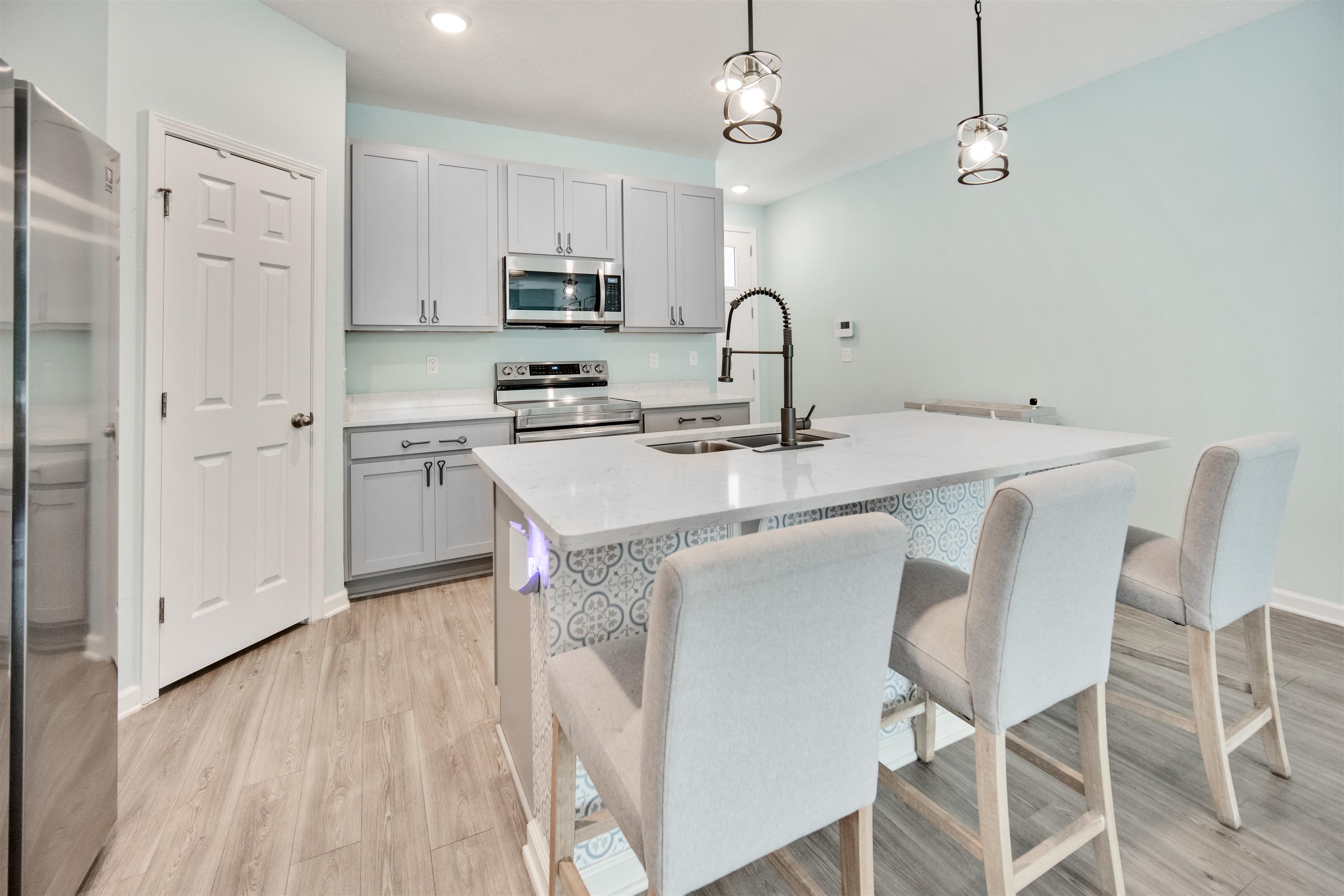 98 Ridge Lake Road St. Augustine, FL 32086 - Photo 10 of 31 a kitchen with stainless steel appliances a table and chairs in it