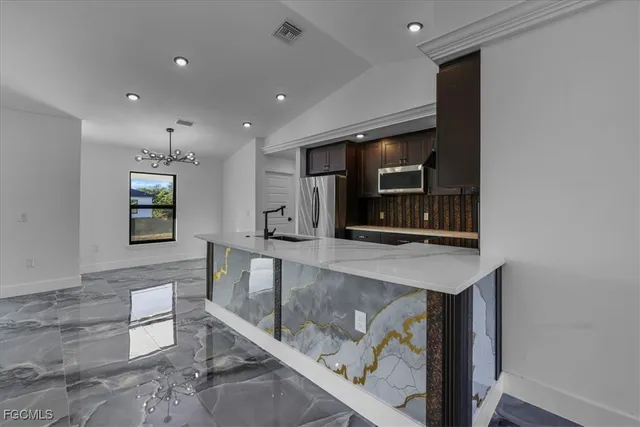 a kitchen with stainless steel appliances wooden cabinets and a counter top space