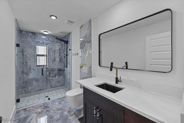 a bathroom with a sink a mirror and shower