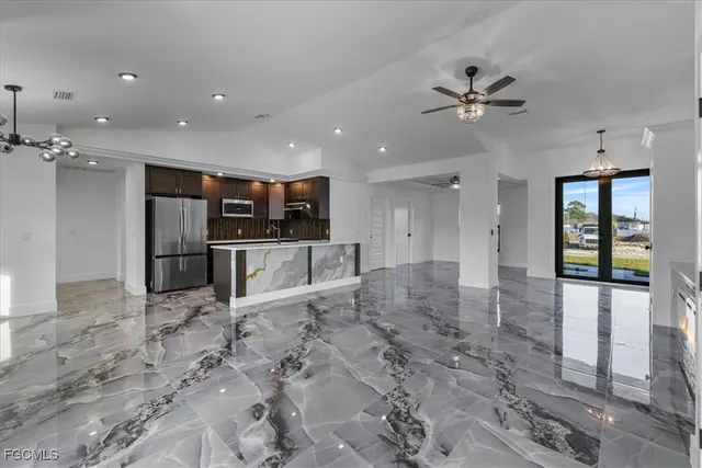 a view of a kitchen with a sink and stainless steel appliances