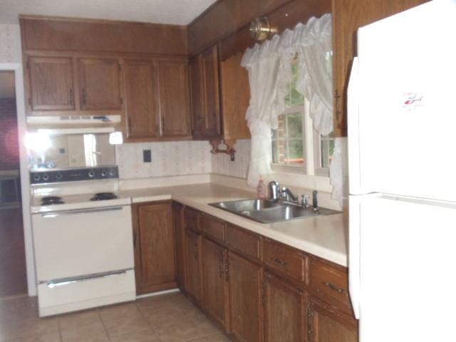 1998 Hidden Hills Road Pulaski, TN 38478 - Photo 7 of 20 a kitchen with a sink stove and cabinets