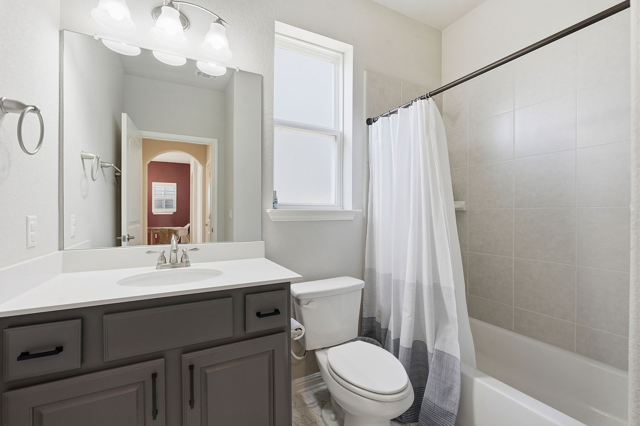 5720 Baythorne Drive Austin, TX 78747 - Photo 12 of 19 a bathroom with a sink a toilet and a mirror