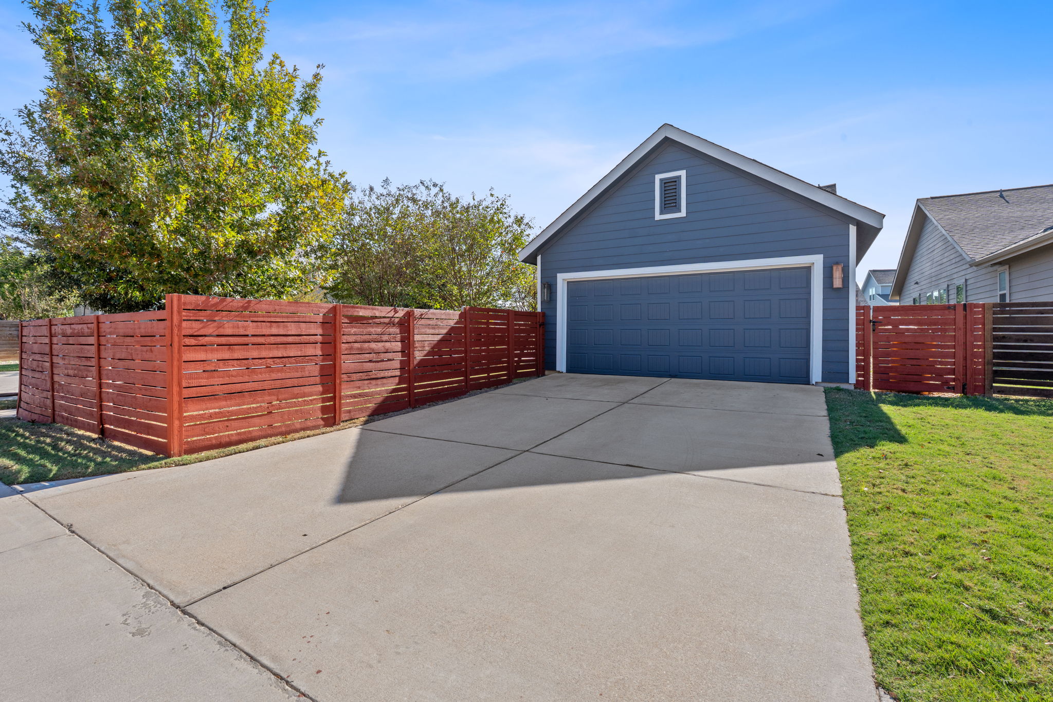 5720 Baythorne Drive Austin, TX 78747 - Photo 19 of 19 a front view of a house with a yard and garage