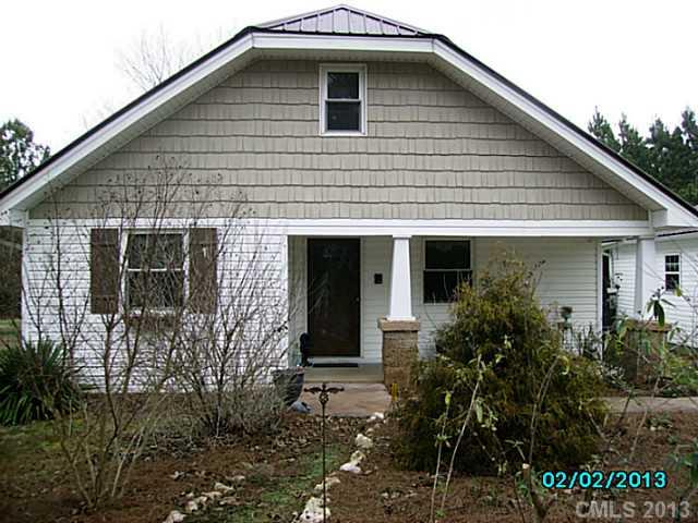 7680 Stokes Ferry Road Salisbury, NC 28146 - Photo 1 of 16 a front view of a house with garden
