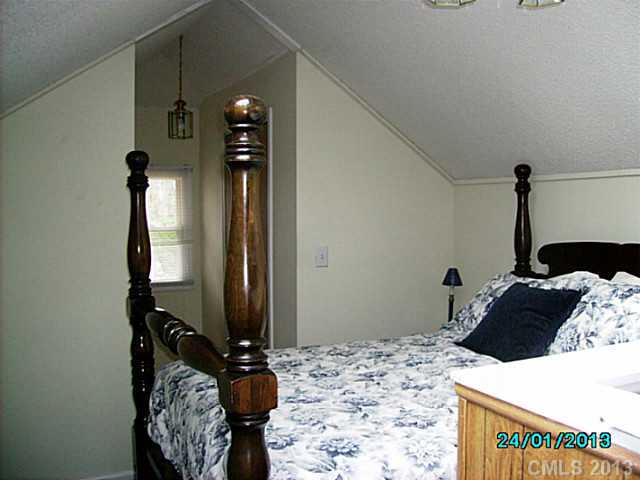 7680 Stokes Ferry Road Salisbury, NC 28146 - Photo 11 of 16 a bedroom with a bed and dresser
