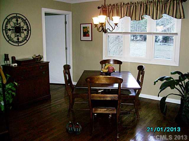 7680 Stokes Ferry Road Salisbury, NC 28146 - Photo 3 of 16 a view of a dining room with furniture and wooden floor