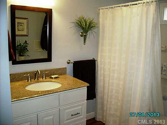 7680 Stokes Ferry Road Salisbury, NC 28146 - Photo 7 of 16 a bathroom with a sink and a mirror