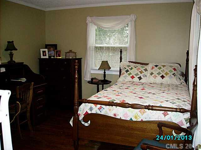 7680 Stokes Ferry Road Salisbury, NC 28146 - Photo 8 of 16 a bedroom with a bed and a window
