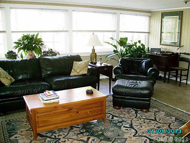 7680 Stokes Ferry Road Salisbury, NC 28146 - Photo 9 of 16 a living room with patio furniture and a potted plant