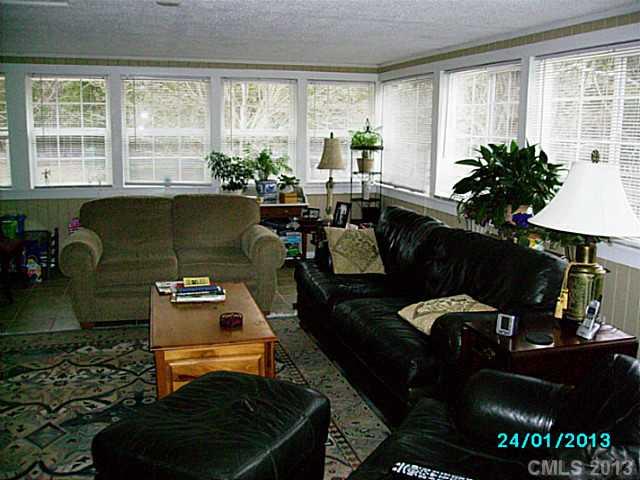 7680 Stokes Ferry Road Salisbury, NC 28146 - Photo 10 of 16 a living room with furniture and a floor to ceiling window
